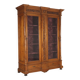 Antique walnut wardrobe with glass and carvings, Italy, 19th century.