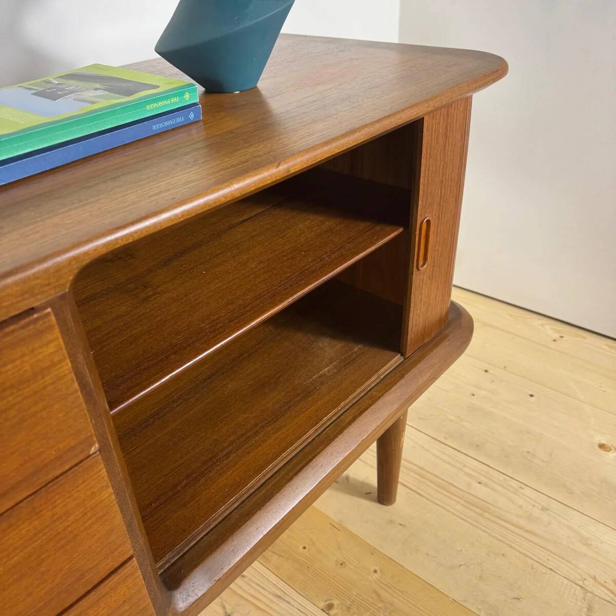 Vintage teak sideboard with rounded edges and sliding doors – mid-century Scandinavian design.