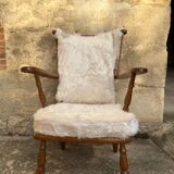 Scandinavian armchair in solid wood with beige fur cushion