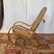 Antique rocking chair in curved wood and caning.