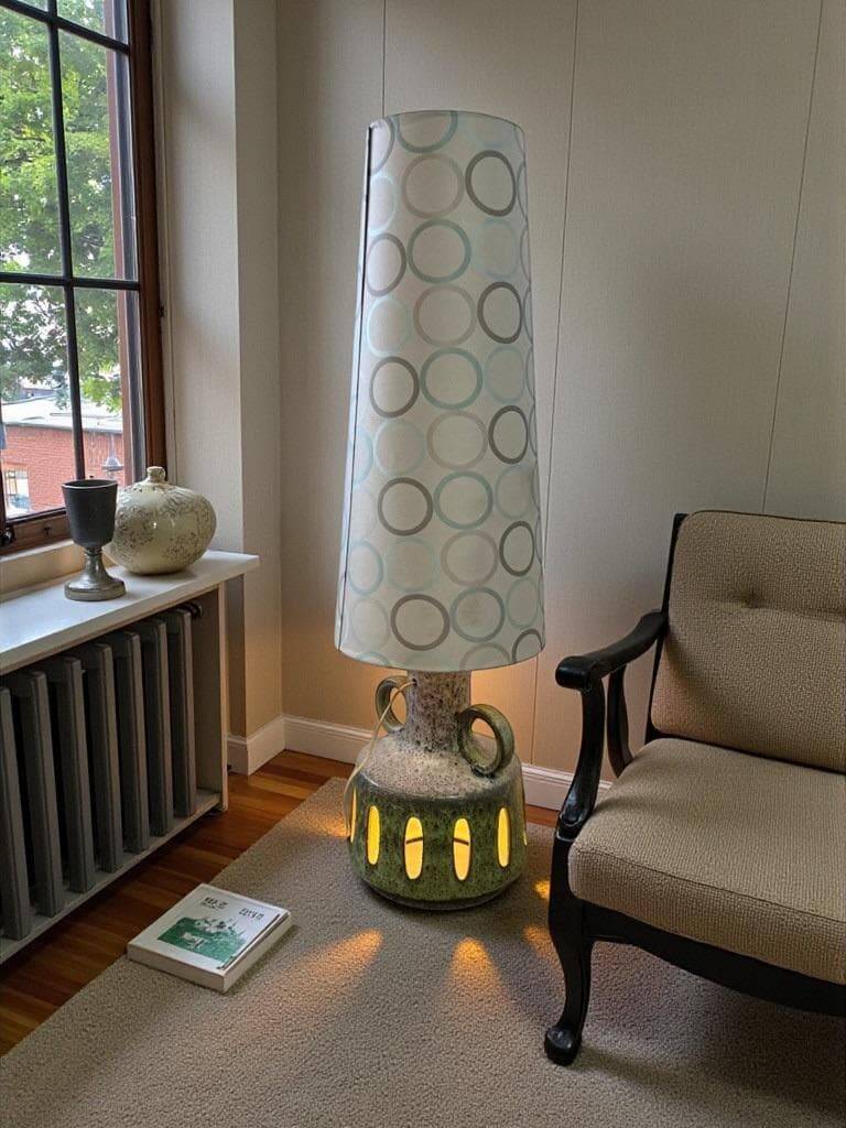 Vintage ceramic floor lamp with illuminated base.