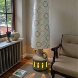 Vintage ceramic floor lamp with illuminated base.