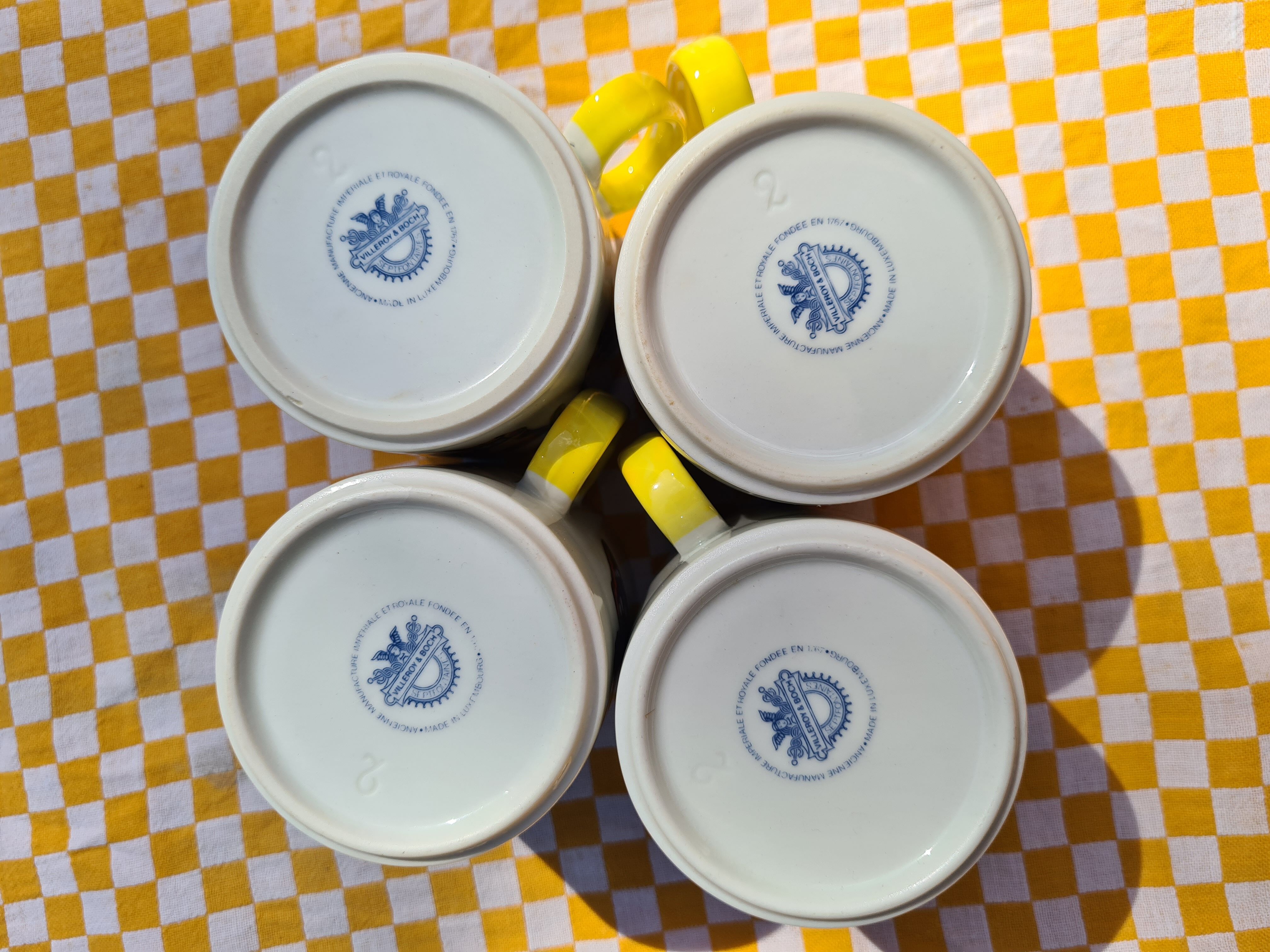 Four mugs decorated with Villeroy and Boch butterflies