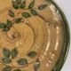 Decorative glazed terracotta plate with olive leaf pattern.