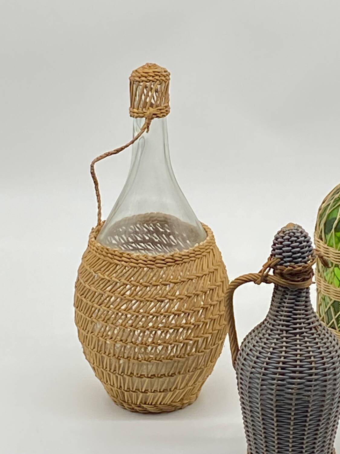 Trio bottles / lady Jeanne, dressed in wicker, rattan, natural fibers