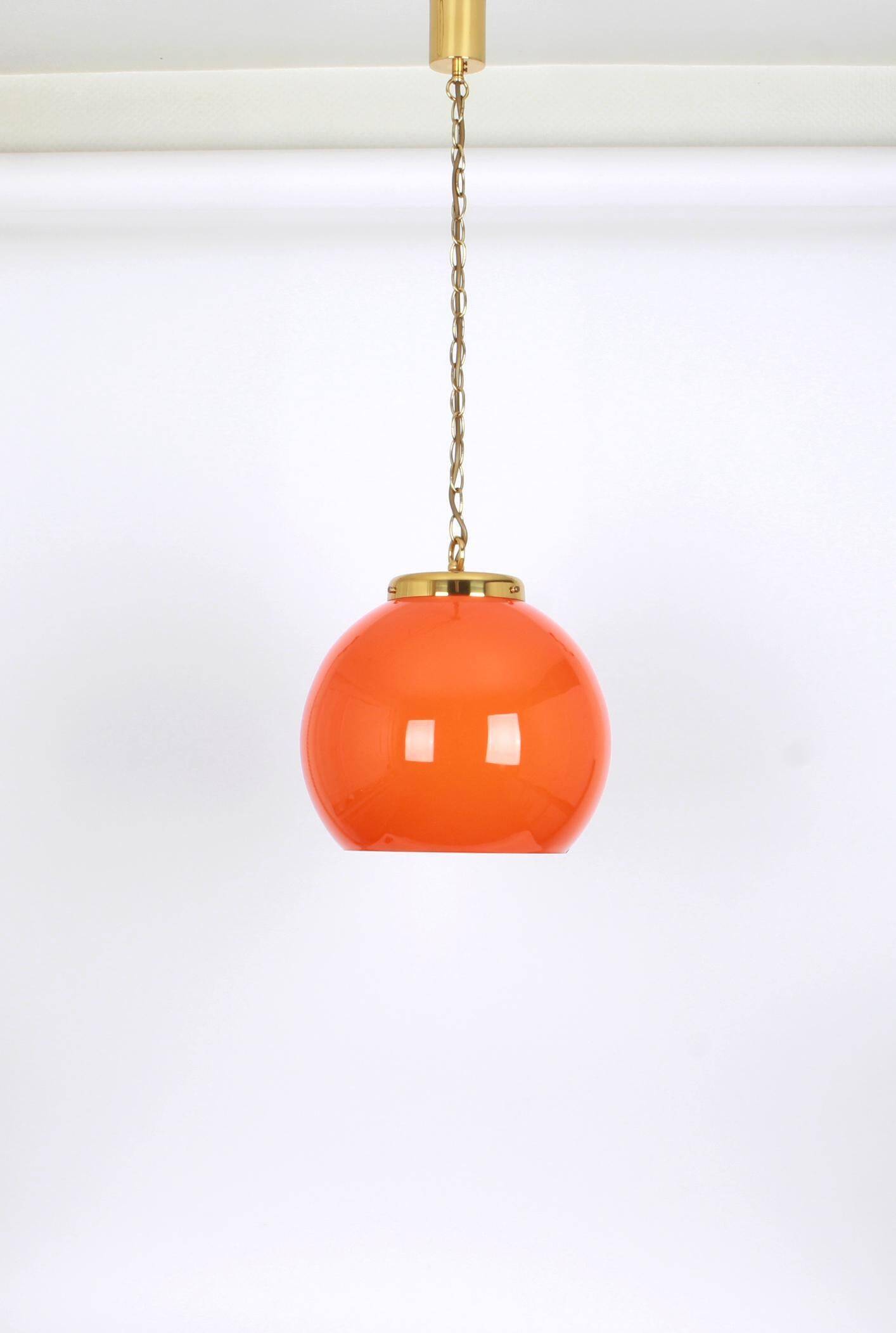 Orange glass pendant light by Peill Putzler, Germany, 1970.