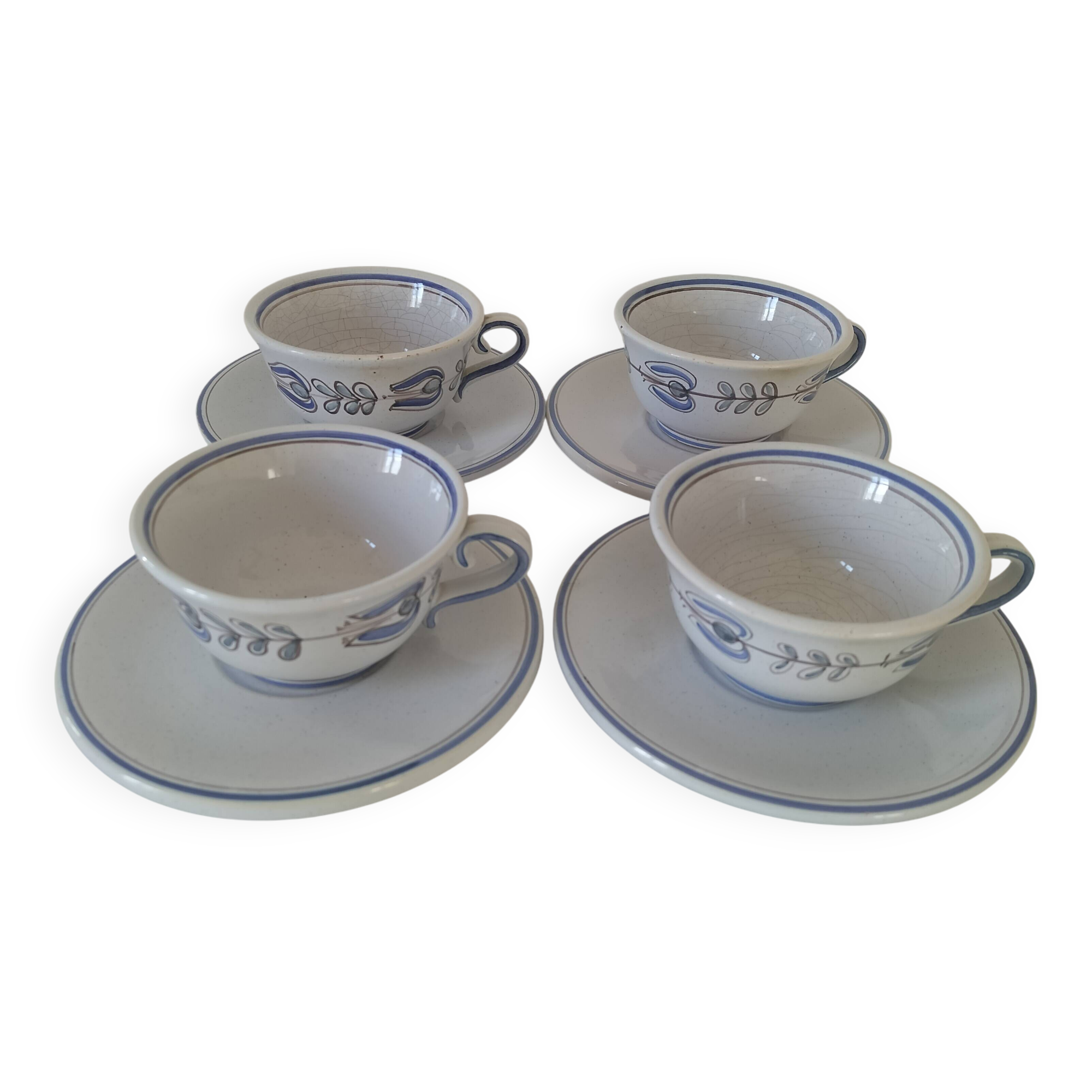 Glazed earthenware cups and saucers