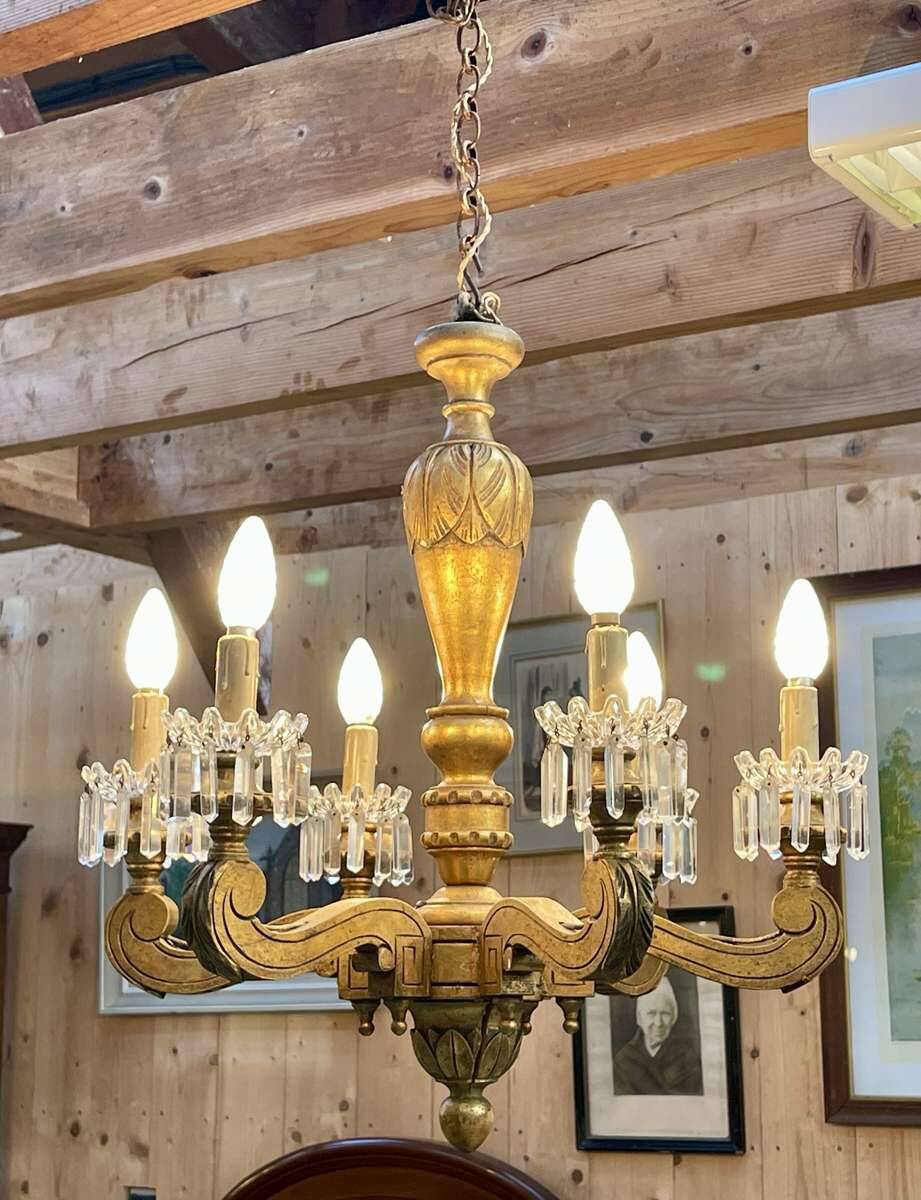 Golden wooden chandelier with crystal pendants from the 19th century.