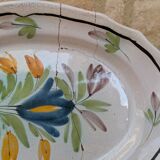 Old oval dish with floral motif called black bottom with staples