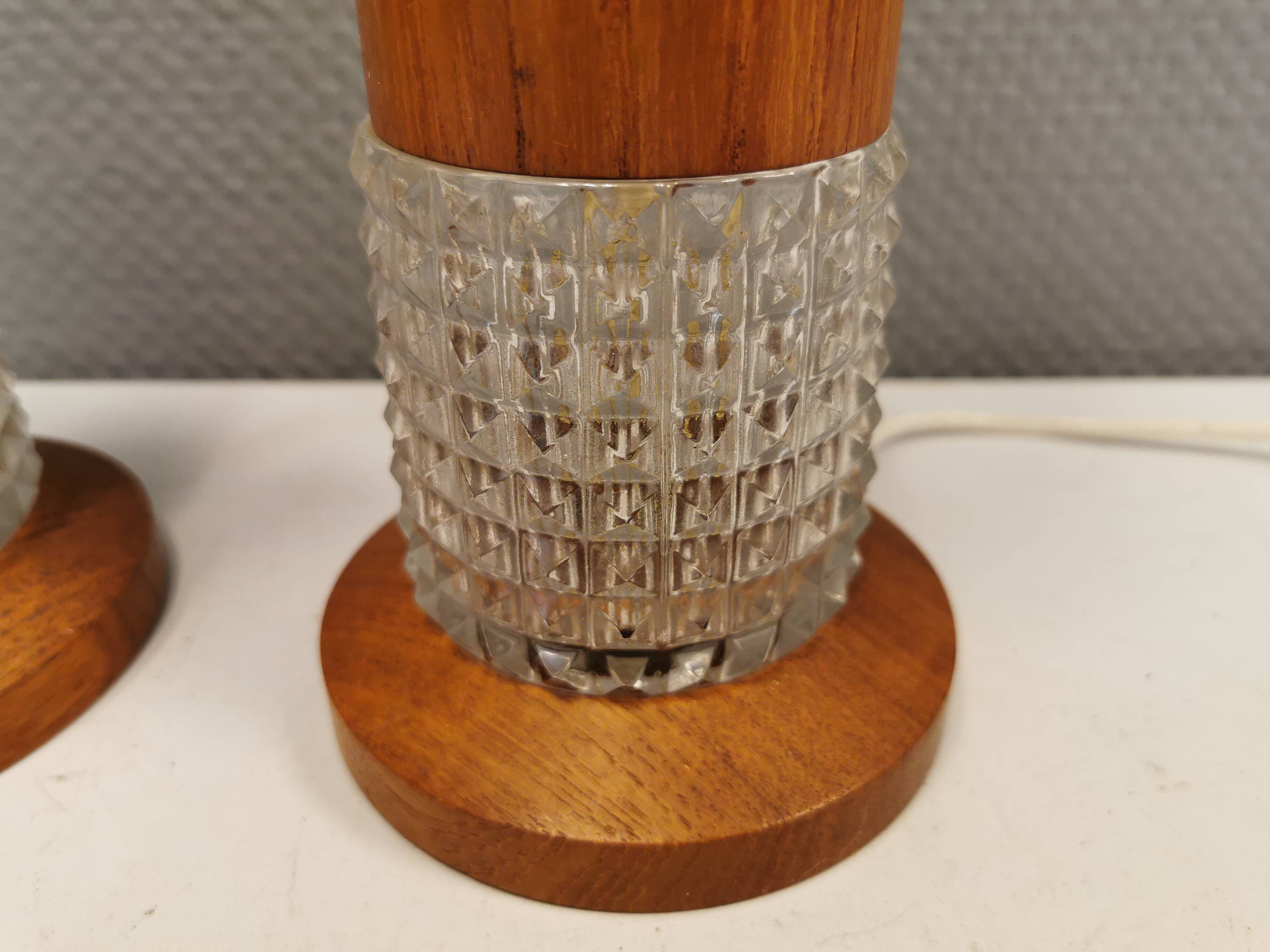 Swedish table lamps made of teak wood and hard pressed crystal glass.