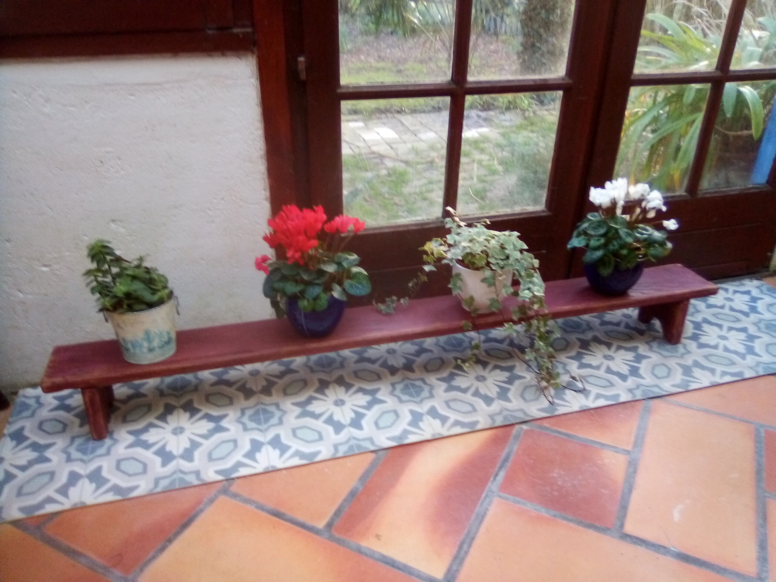 Low bench rests feet in patinated wood