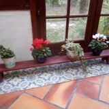 Low bench rests feet in patinated wood