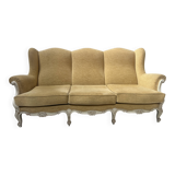 Louis XV style three-seater wingback sofa in patinated beech, 20th century