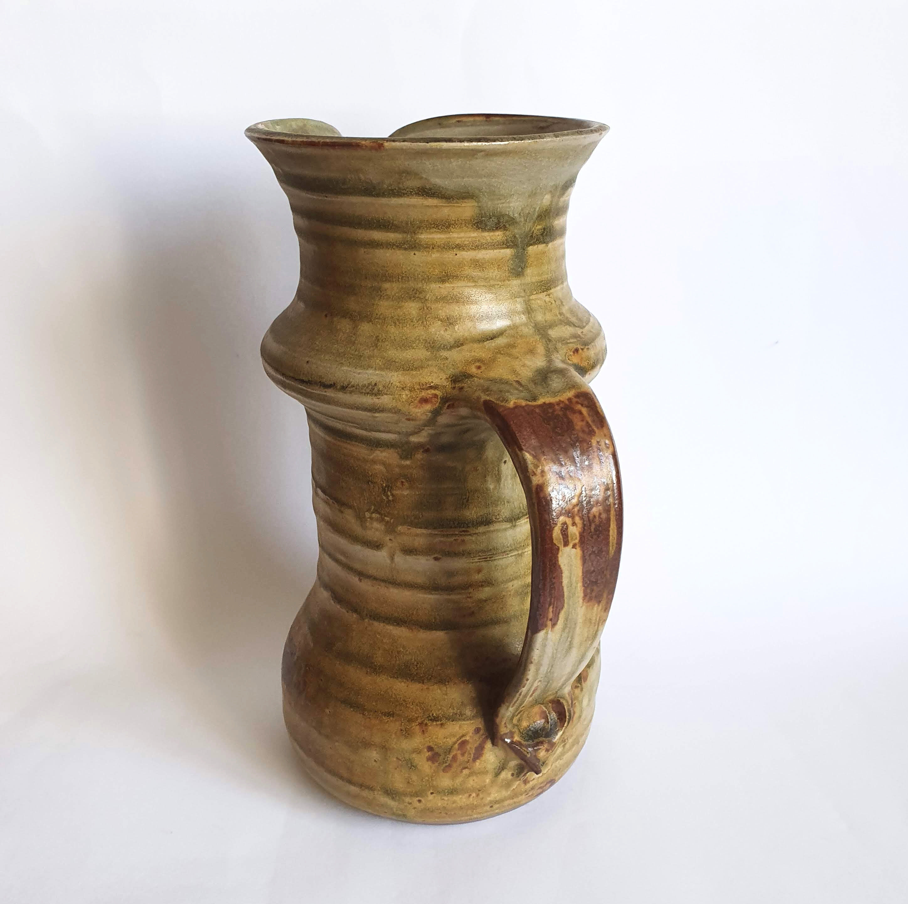 Enamelled sandstone pitcher signed