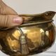 Pair of brass plant pots, decorated with cord and tassels.