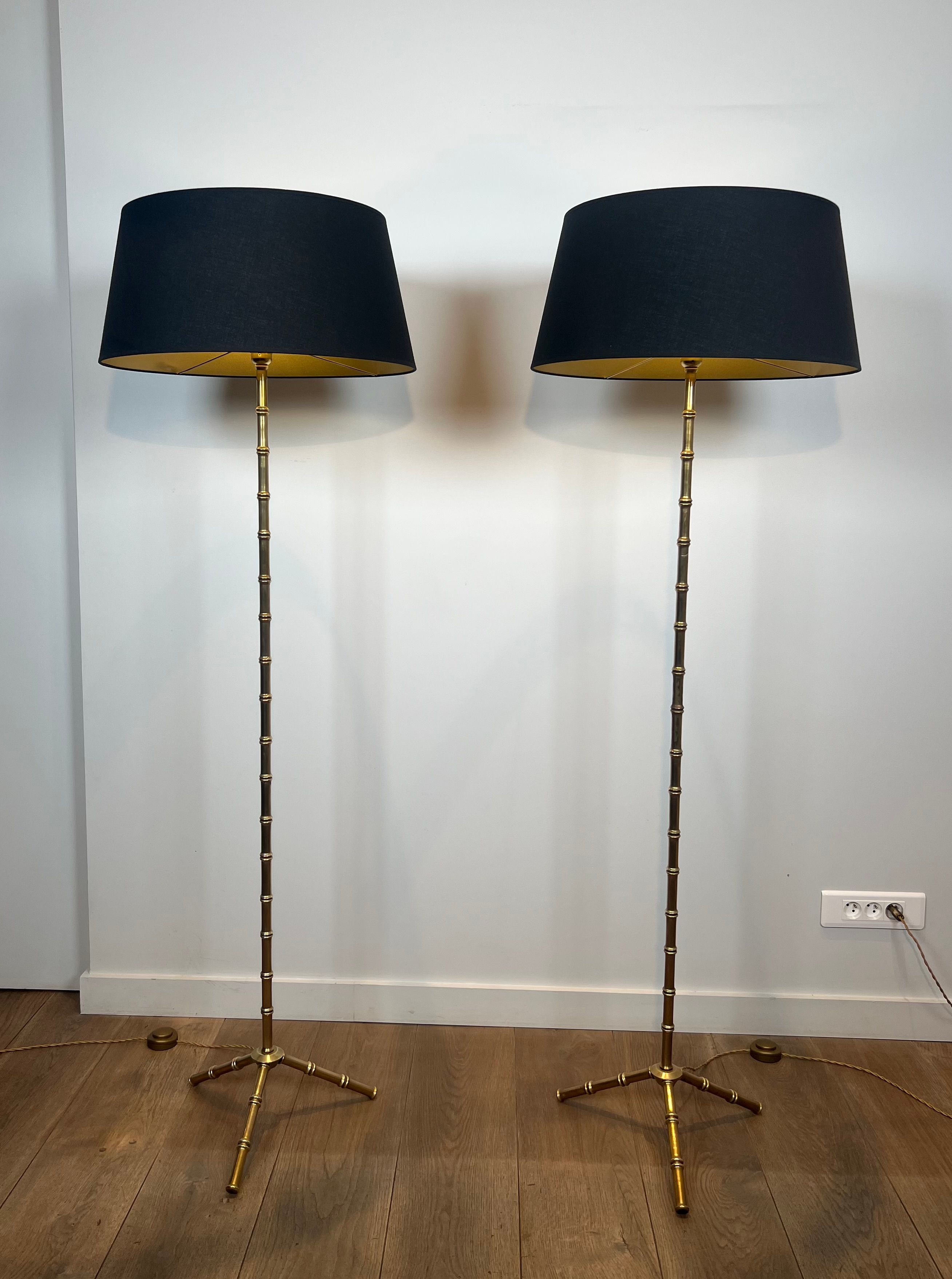 Pair of parquet floor lamps in faux-bamboo style in bronze and brass by Jacques Adnet.