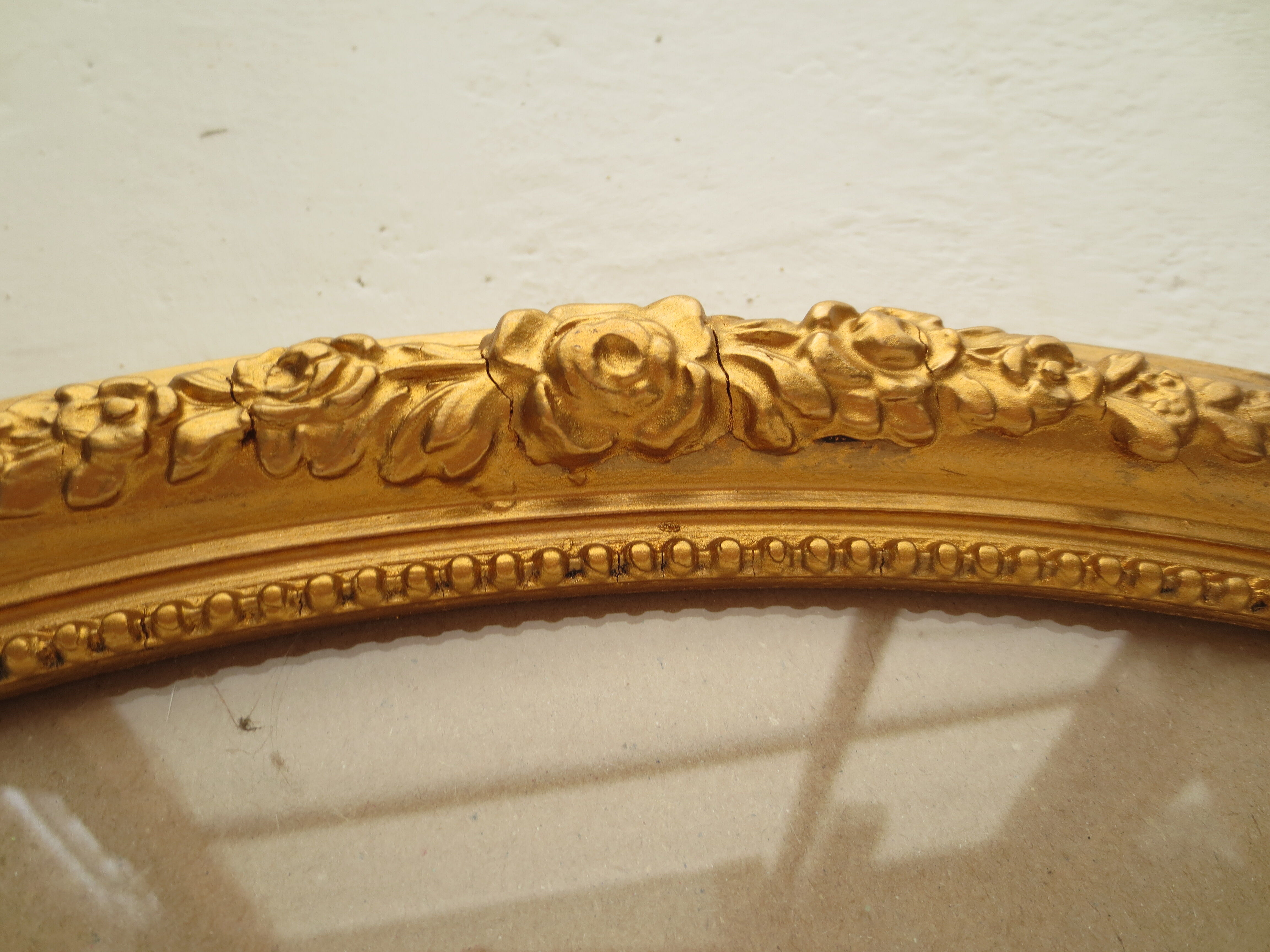 Large old oval gilded wooden frame and stucco decorations