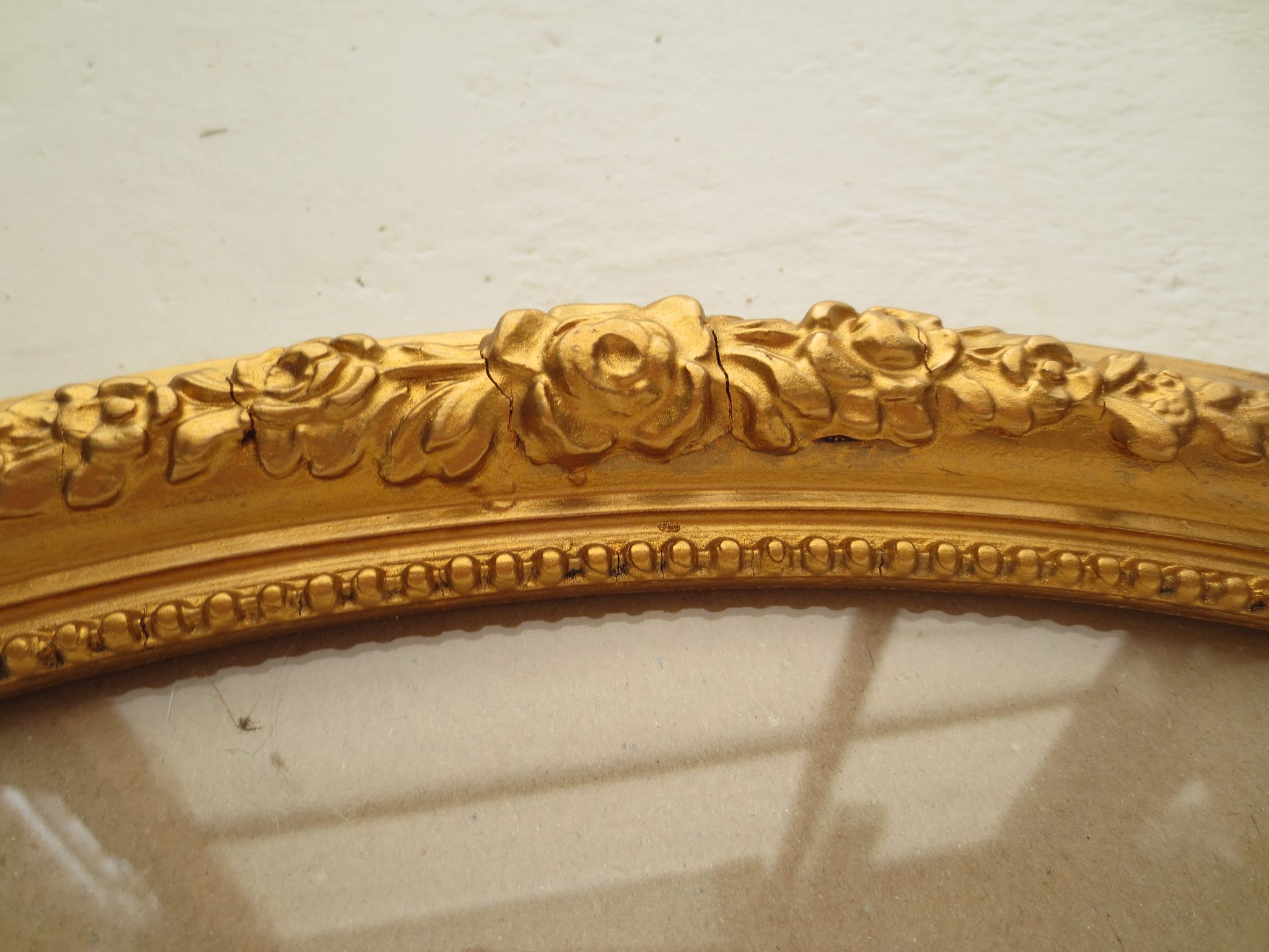 Large old oval gilded wooden frame and stucco decorations