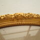 Large old oval gilded wooden frame and stucco decorations