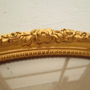 Large old oval gilded wooden frame and stucco decorations