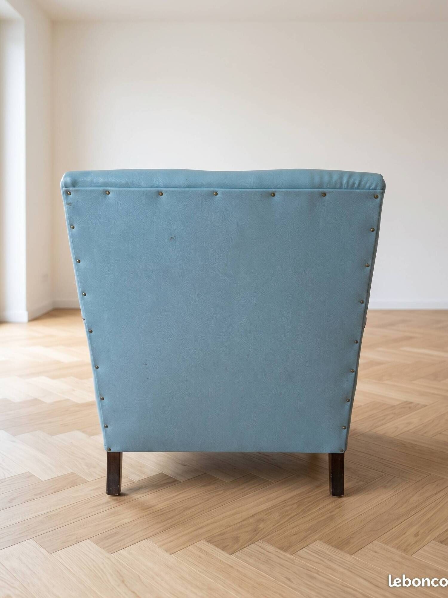 Vintage armchair in light blue faux leather retro style