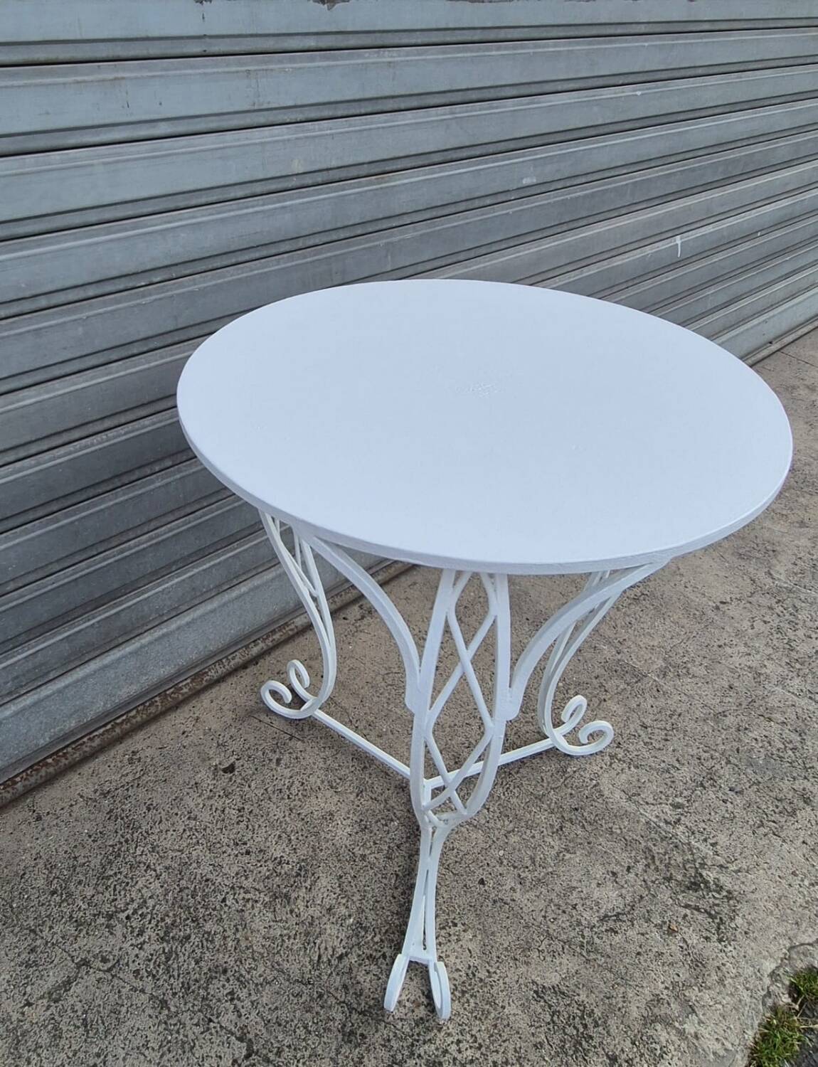 Round white wrought iron garden table