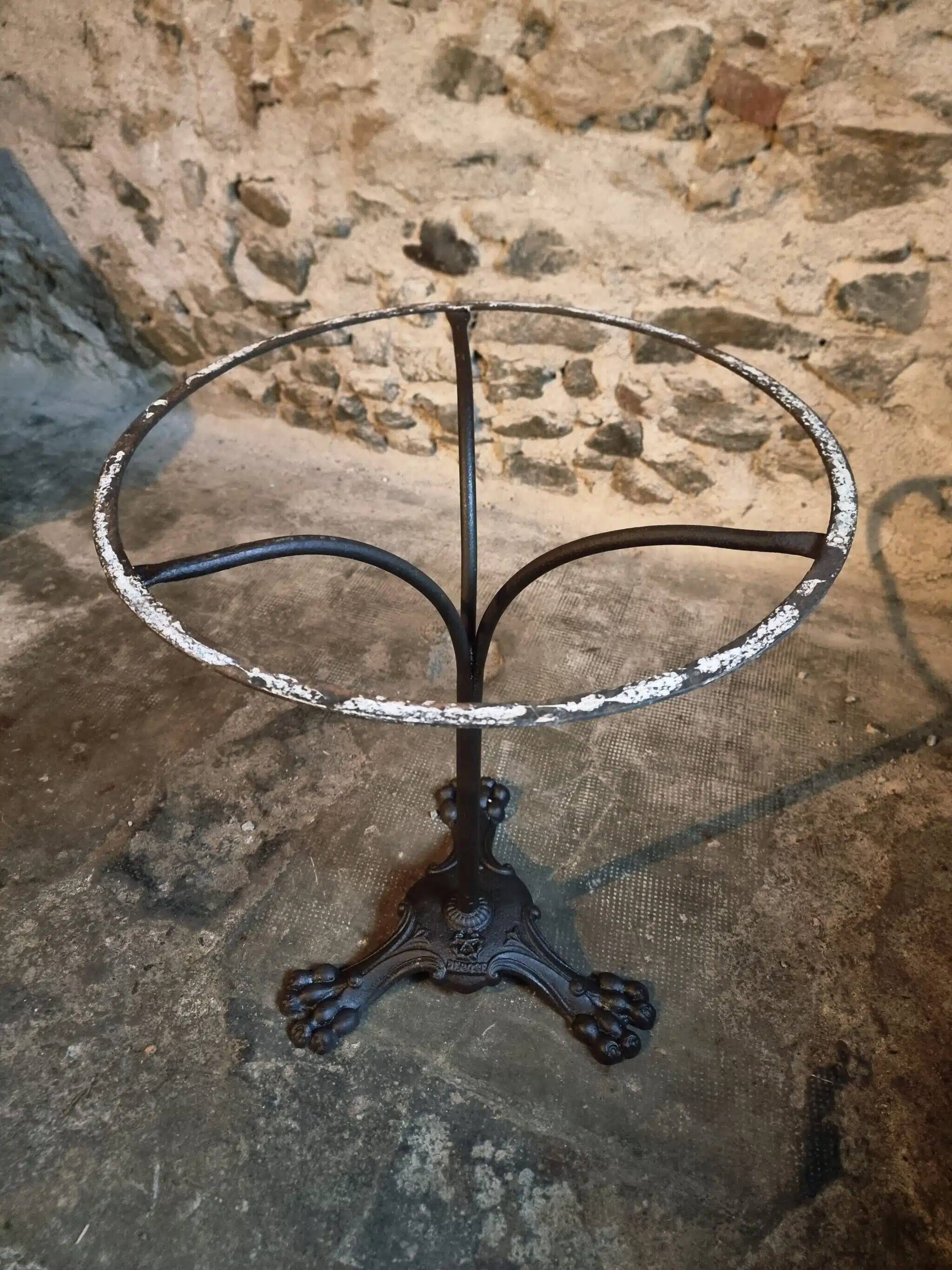 Old French bistro table with a marble top and a cast iron base.