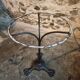 Old French bistro table with a marble top and a cast iron base.