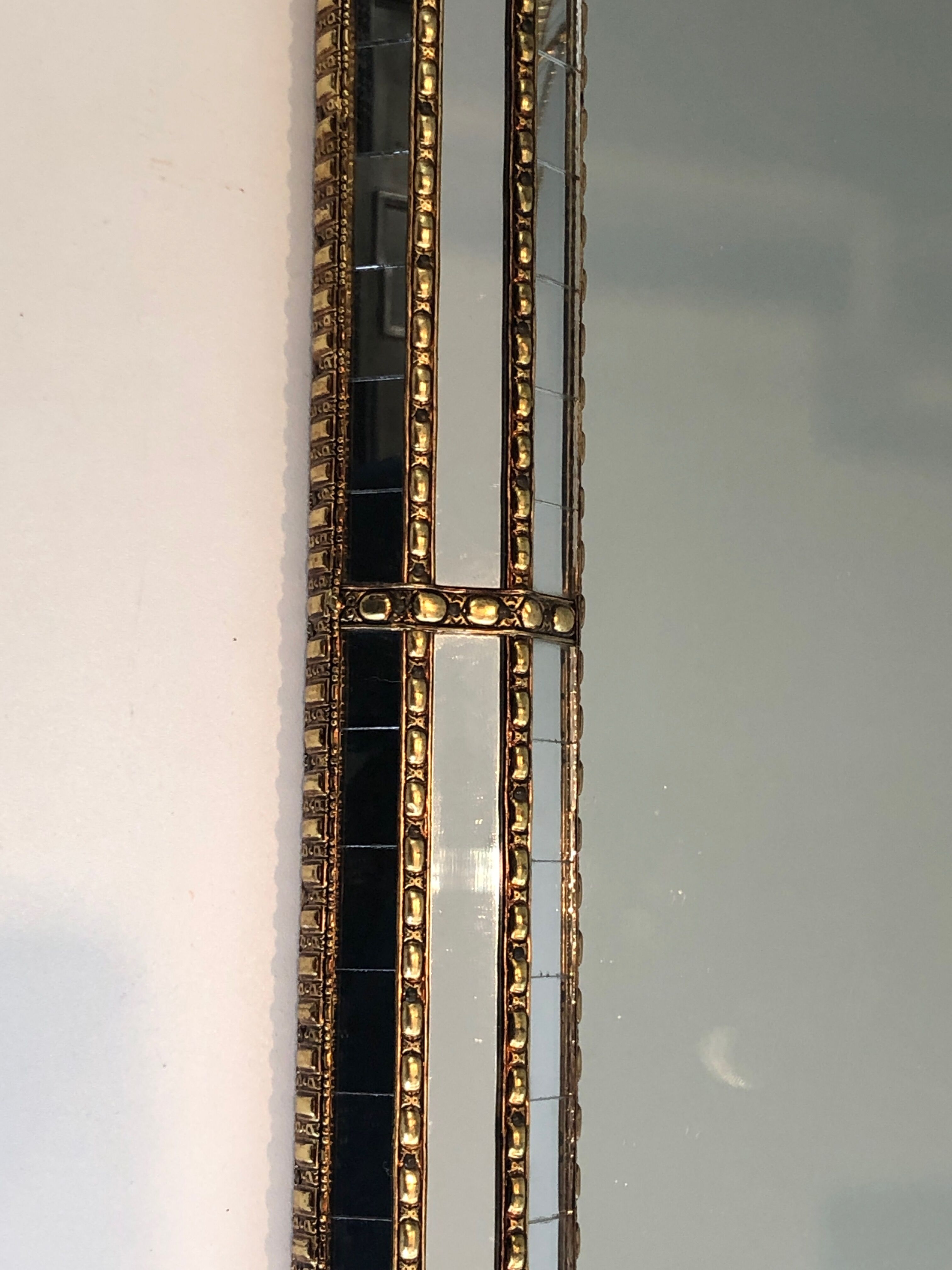 Mirror consisting of multi-faceted mirrors and brass garlands, French work, around 1970