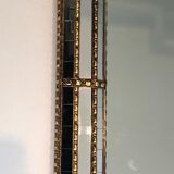 Mirror consisting of multi-faceted mirrors and brass garlands, French work, around 1970