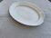 Large oval cream serving platter in ceramic - vintage model from the 1950s, wide rim.