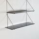 Mid-century vintage shelf in a loop shape, black glass and metal.