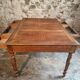 Antique French walnut table with six drawers, parquet top, early 20th century.