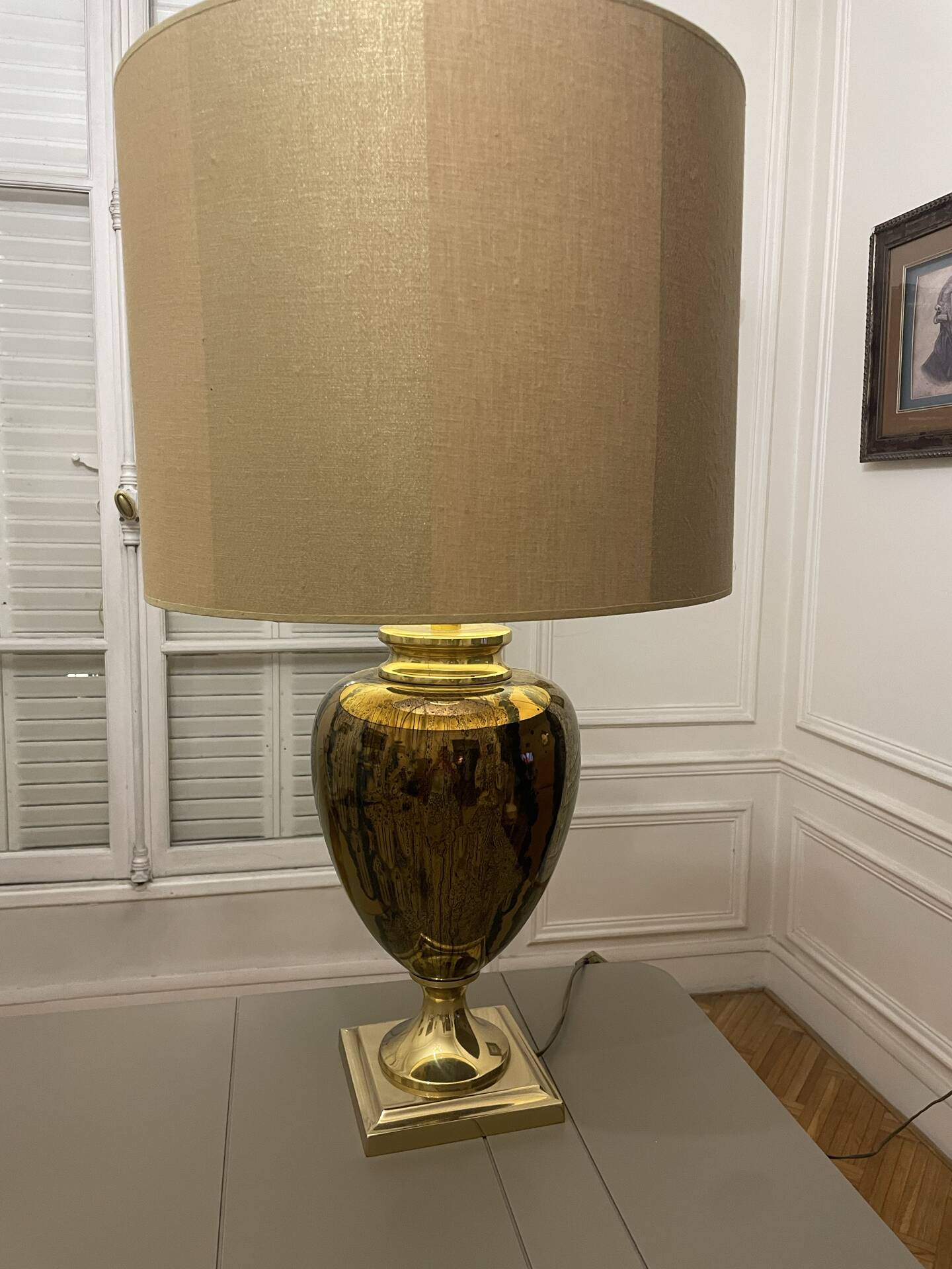 Bronze table lamp with a golden shade.
