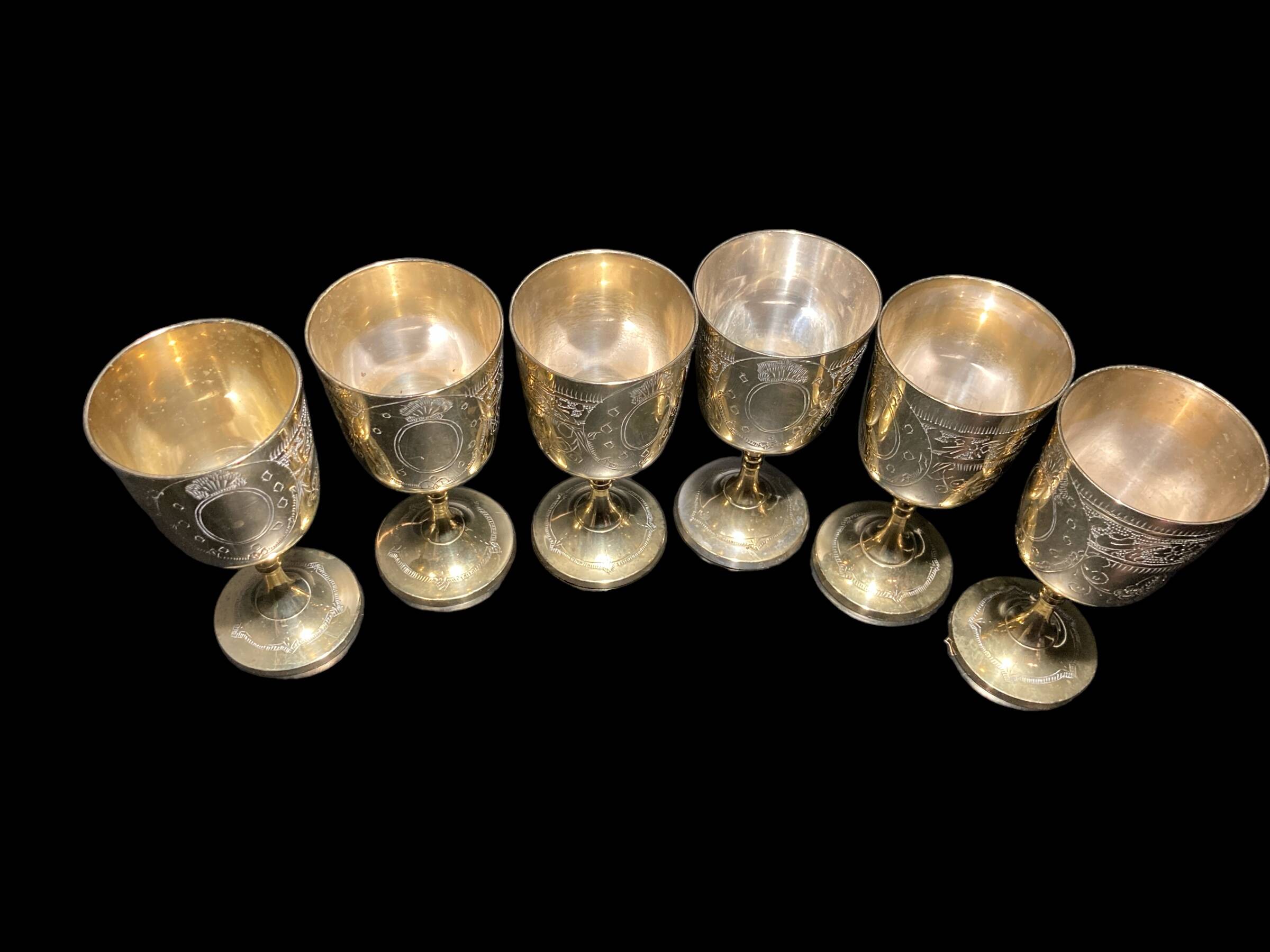 Set of six gold metal glasses