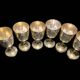 Set of six gold metal glasses
