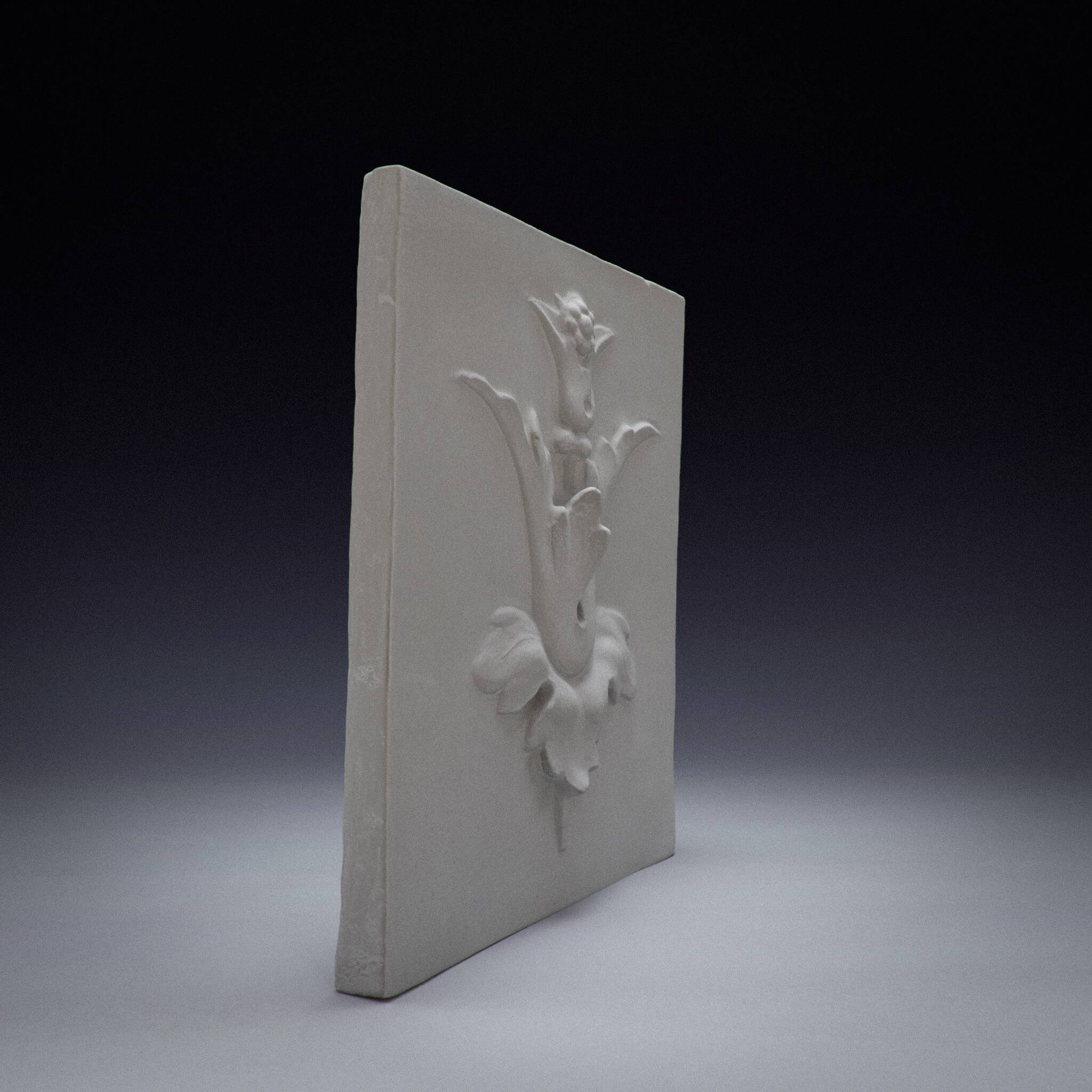 Bas-relief plaster mural with a fleur-de-lis design.