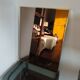 Vintage mirror in gilded brass and smoked glass. circa 1970