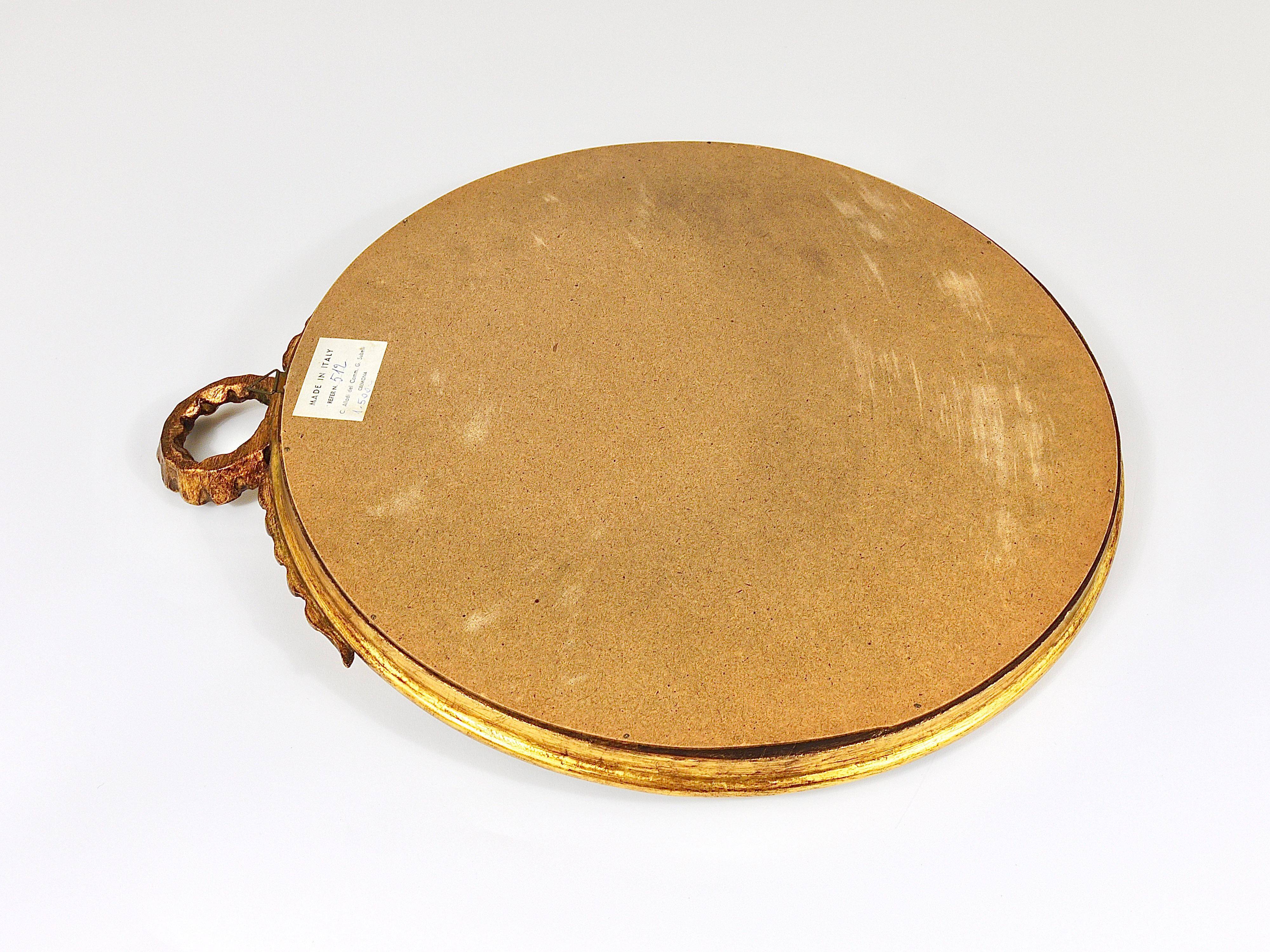 Round wall mirror in gilded wood, mid-century, C. Allodi & G. Subelli, Italy, 1950s.