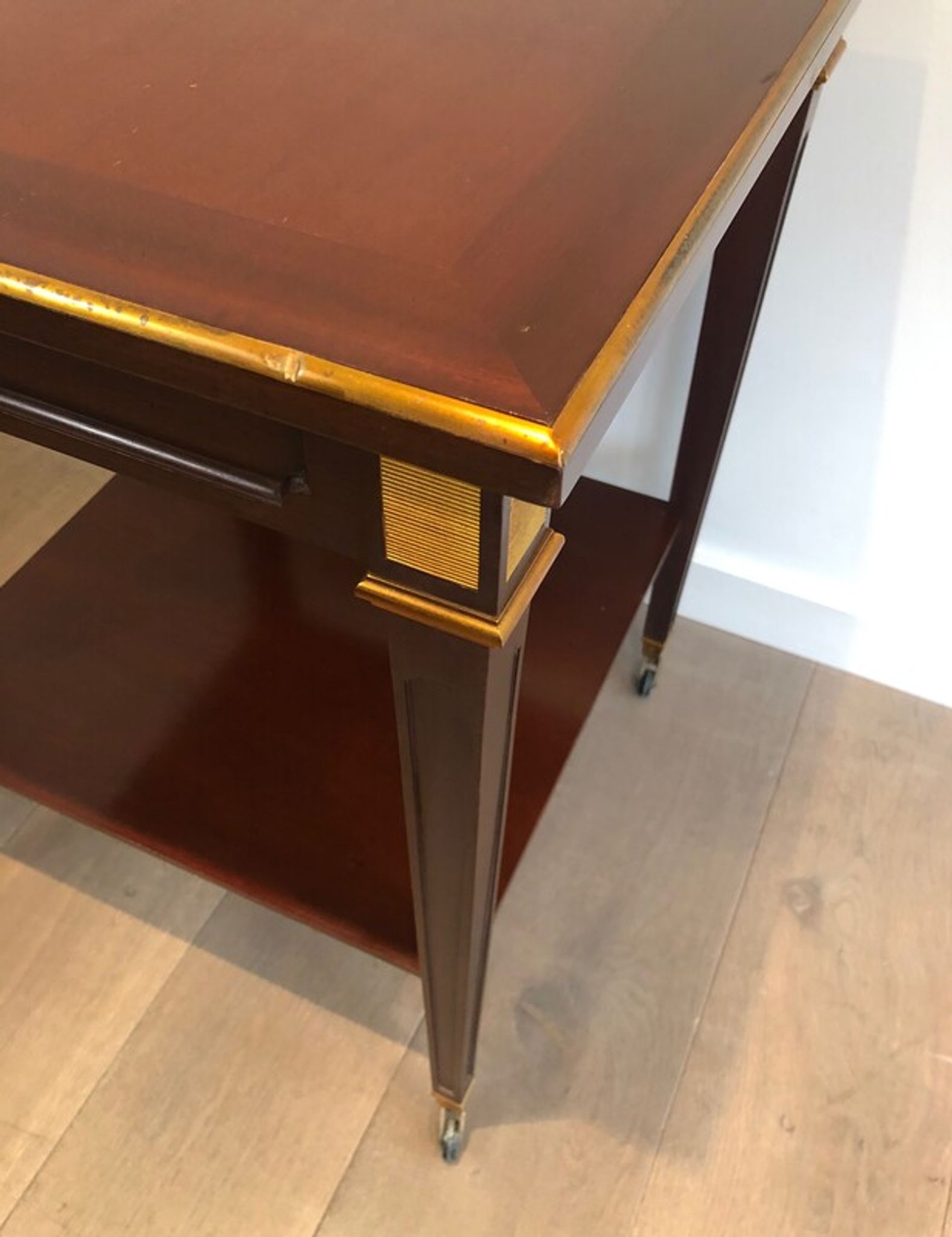 Two-level table in mahogany and brass