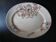 Large antique plate stamped with a fauna and flora pattern.