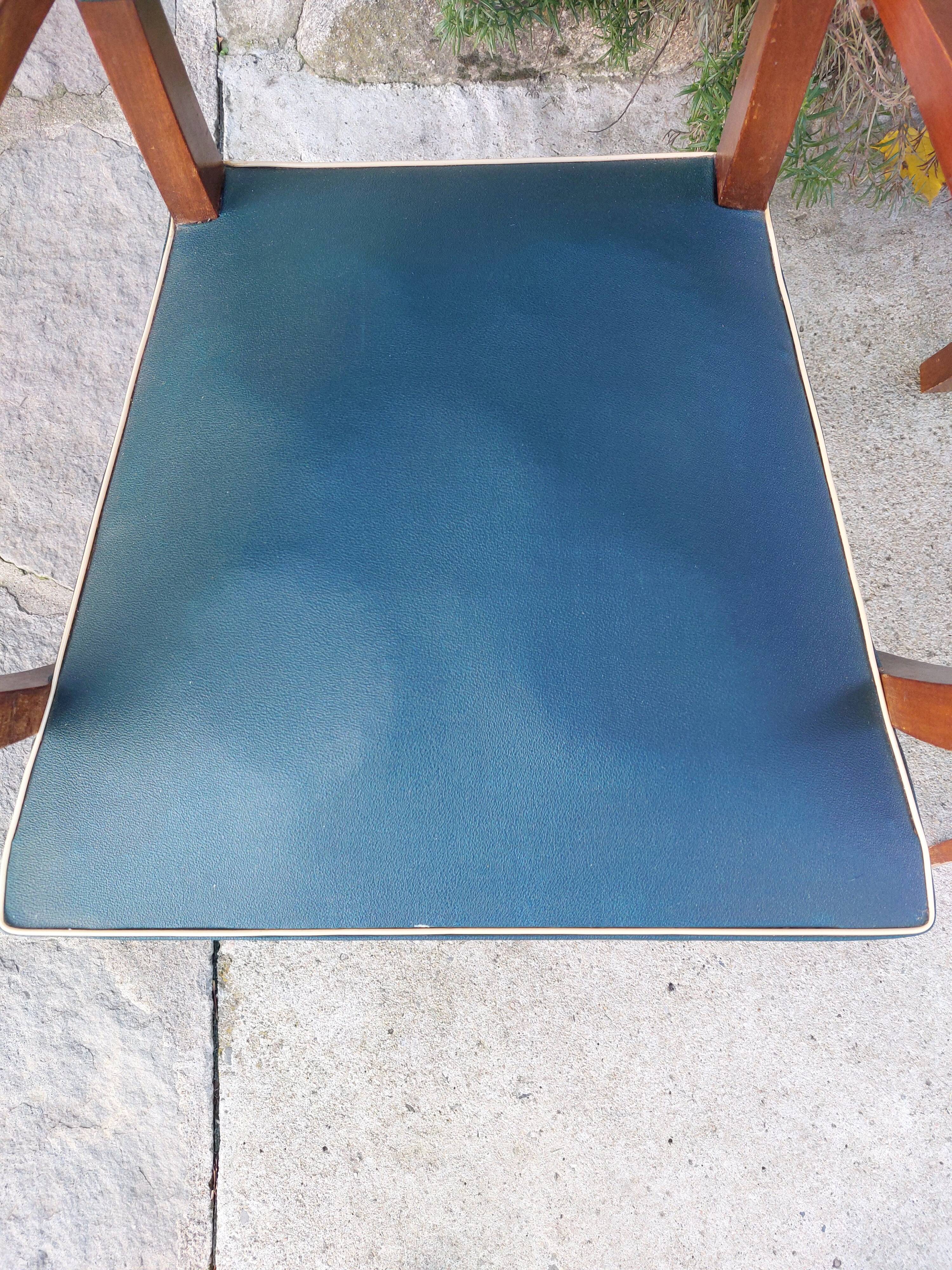 pair of dark green bridge armchairs