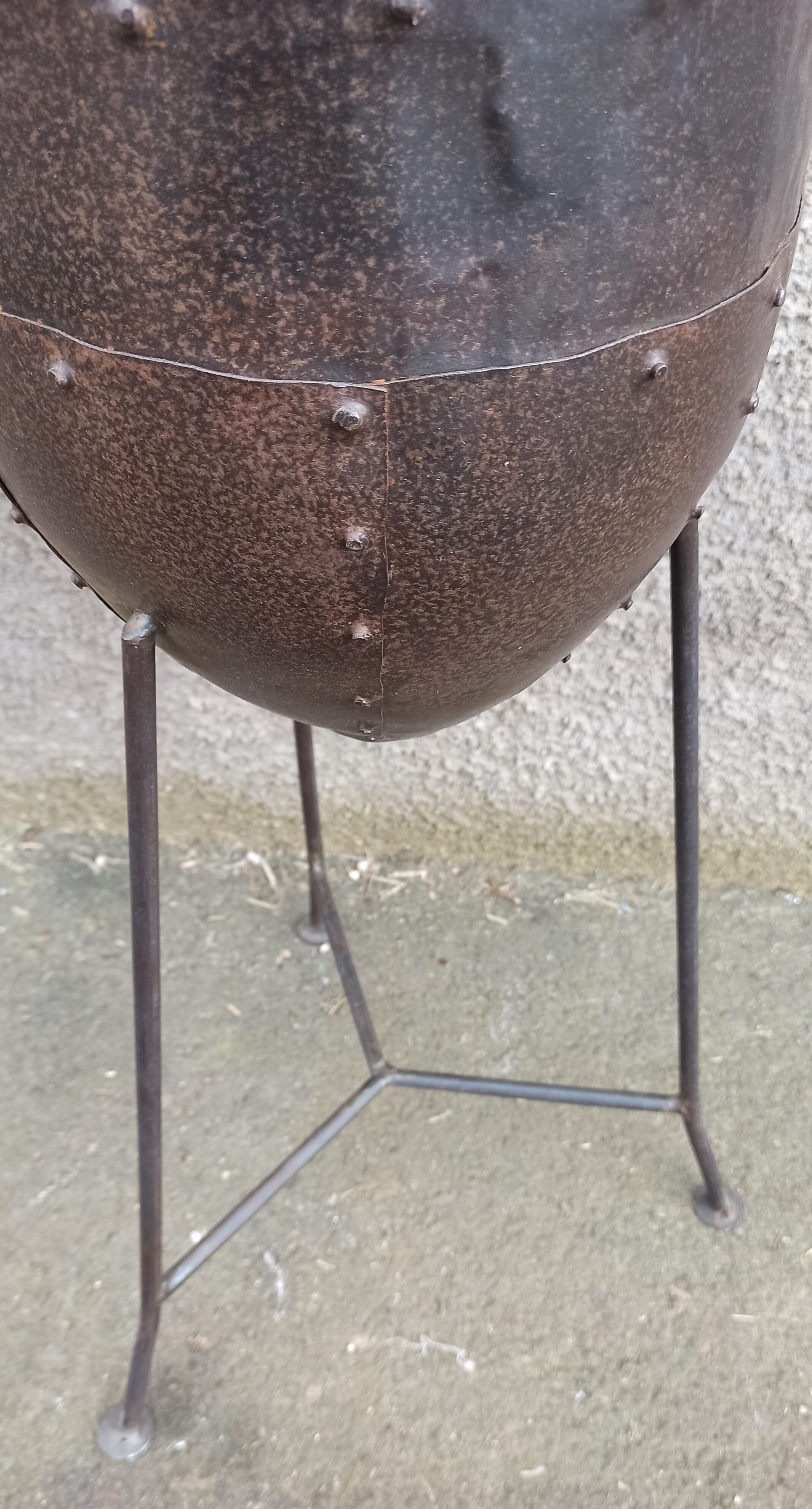 Old metal pot on foot