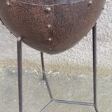 Old metal pot on foot