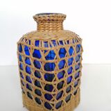 Blue bottle covered with wicker