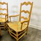 Pair of French Provencal Radassier beech chairs and ottoman, with rush seating.