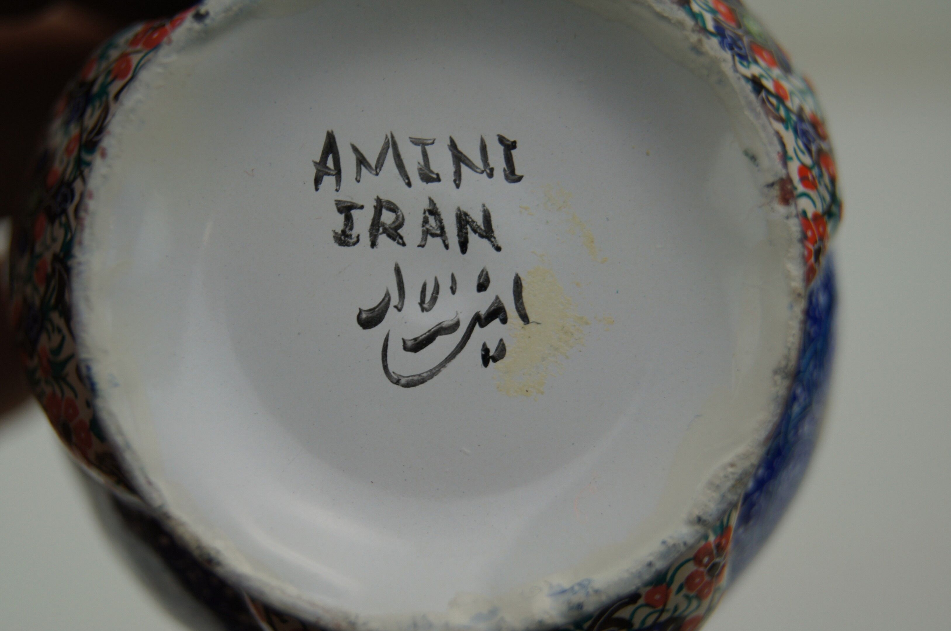 Piriform vase with a flared metal collar enamelled with a polychrome decoration, marked "Amini Iran" on the reverse.