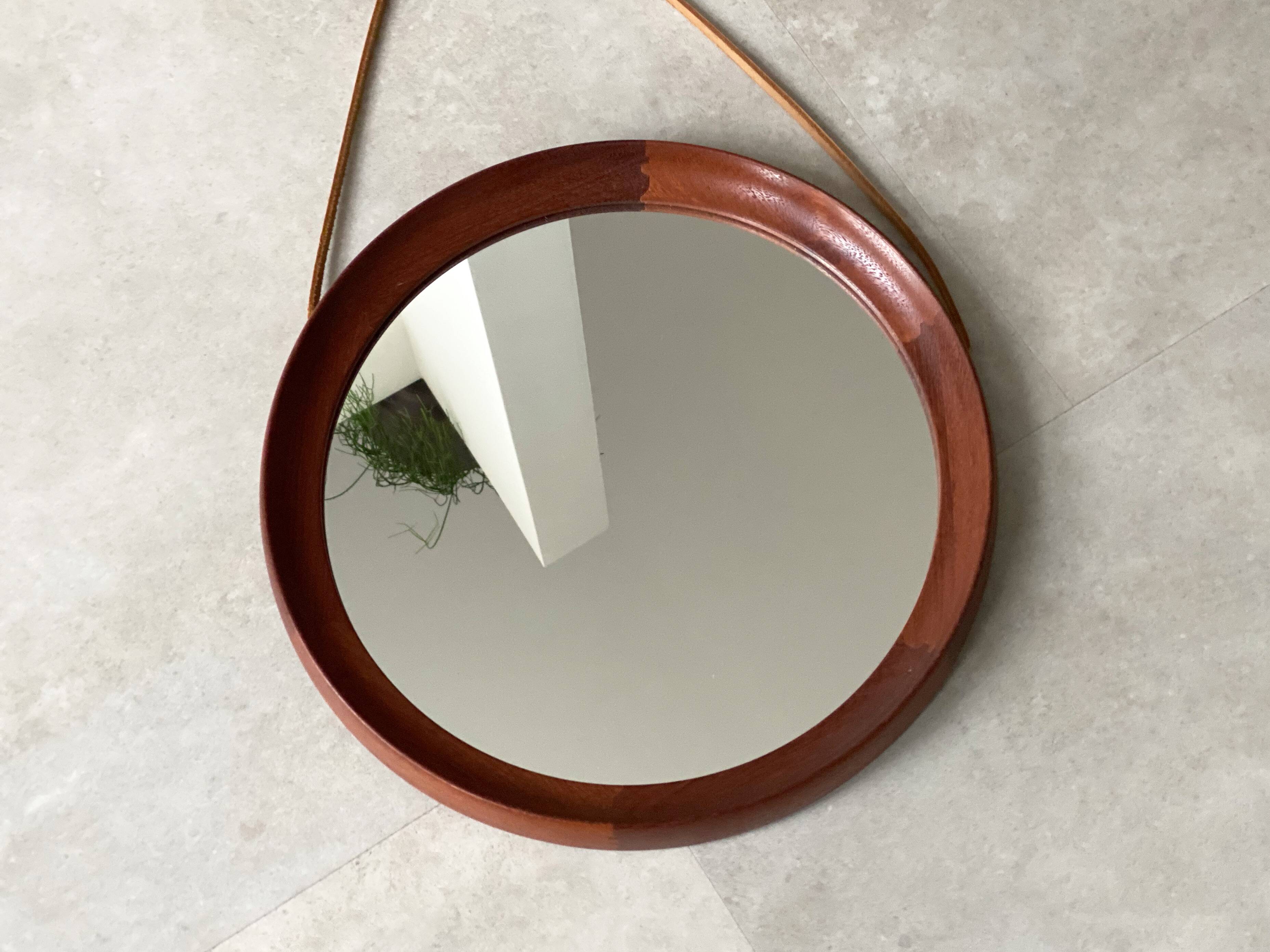 Mid Century solid teak wall mirror with a leather strap - Danish design