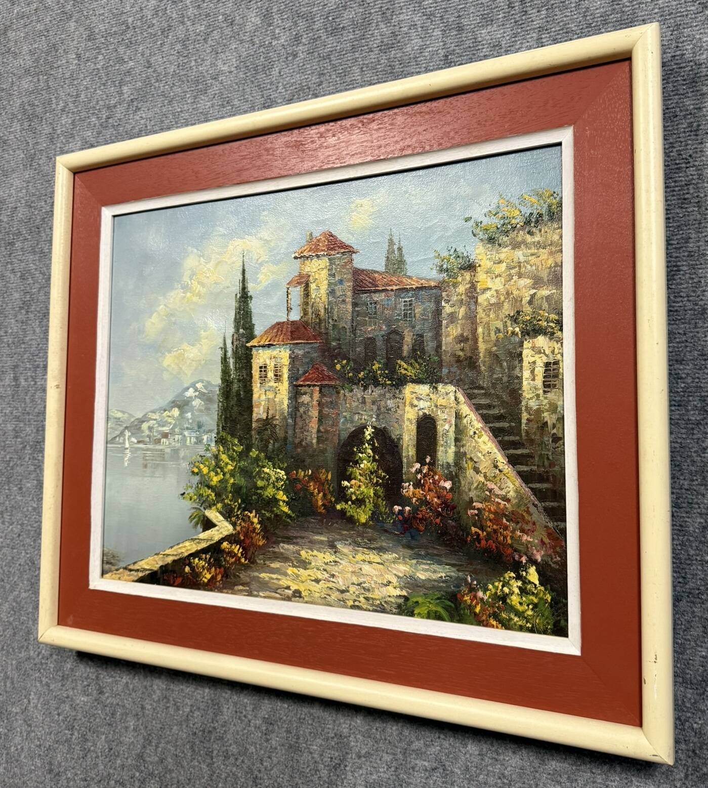 Italian School: painting of a castle on the edge of a lake