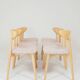 Set of 6 soft pink fabric dining chairs, Scandinavian design, natural wood.